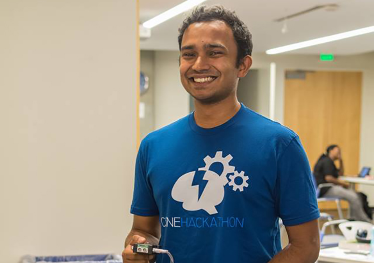 Gaurav Mukherjee holding a device he engineered at the 2016 CSNE Hackathon