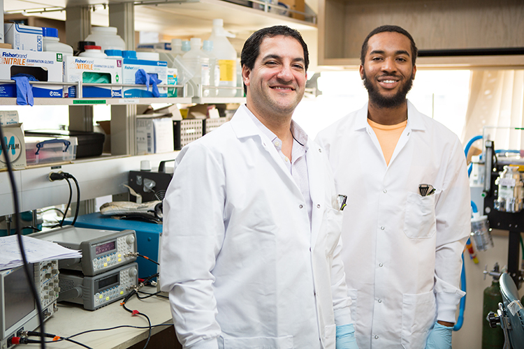 Jesse Woodbury and Dr. Saigal in the lab at UW Medicine