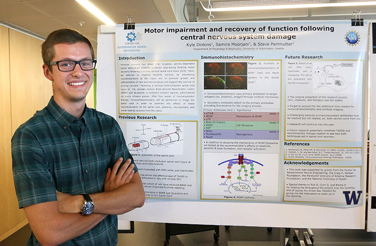 Kyle Dinkins, REU program participant, showing his research project poster